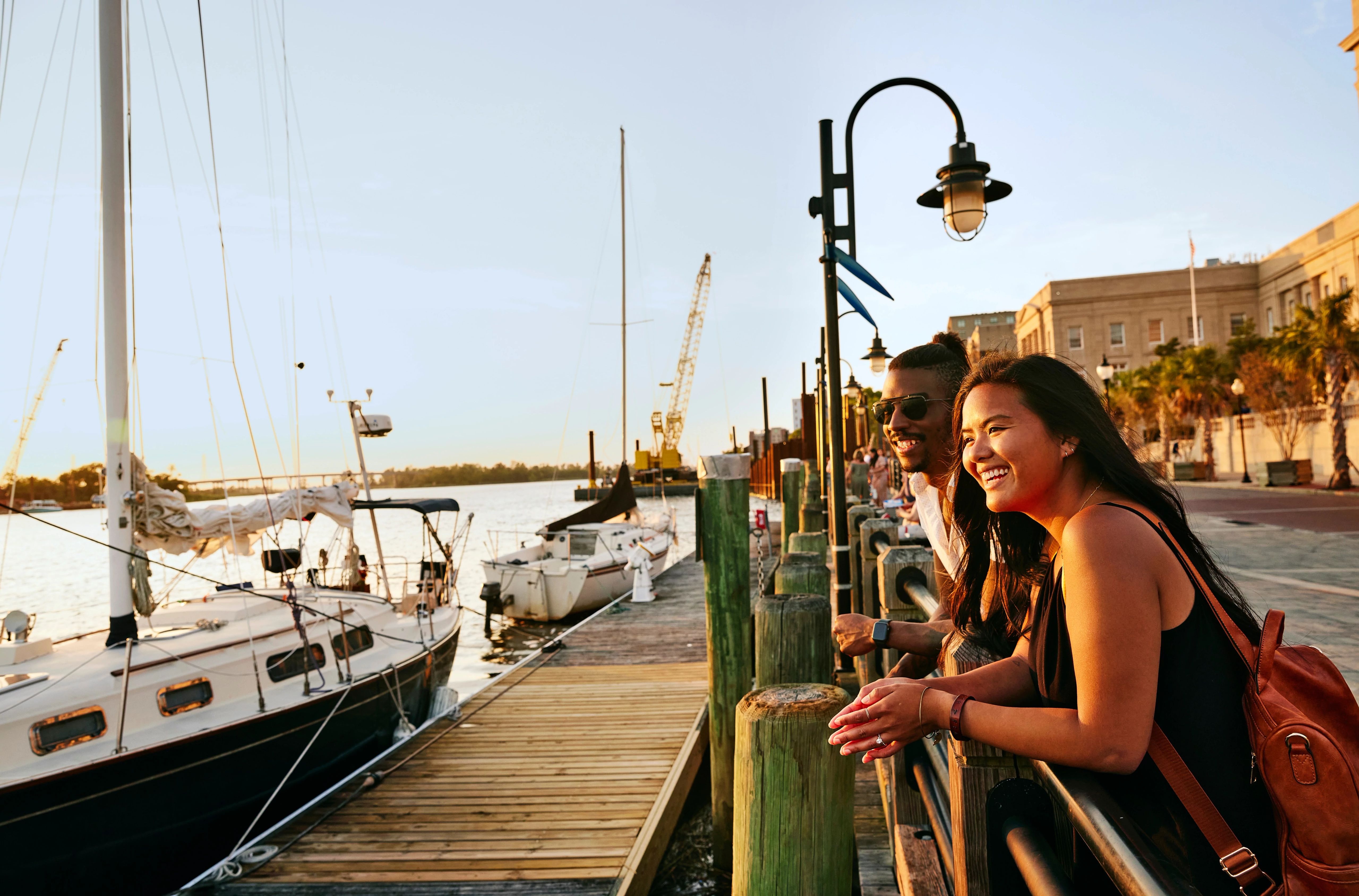 HDNorth CarolinaWilmingtonCape Fear Riverwalk with Couple Smiling at Sunset