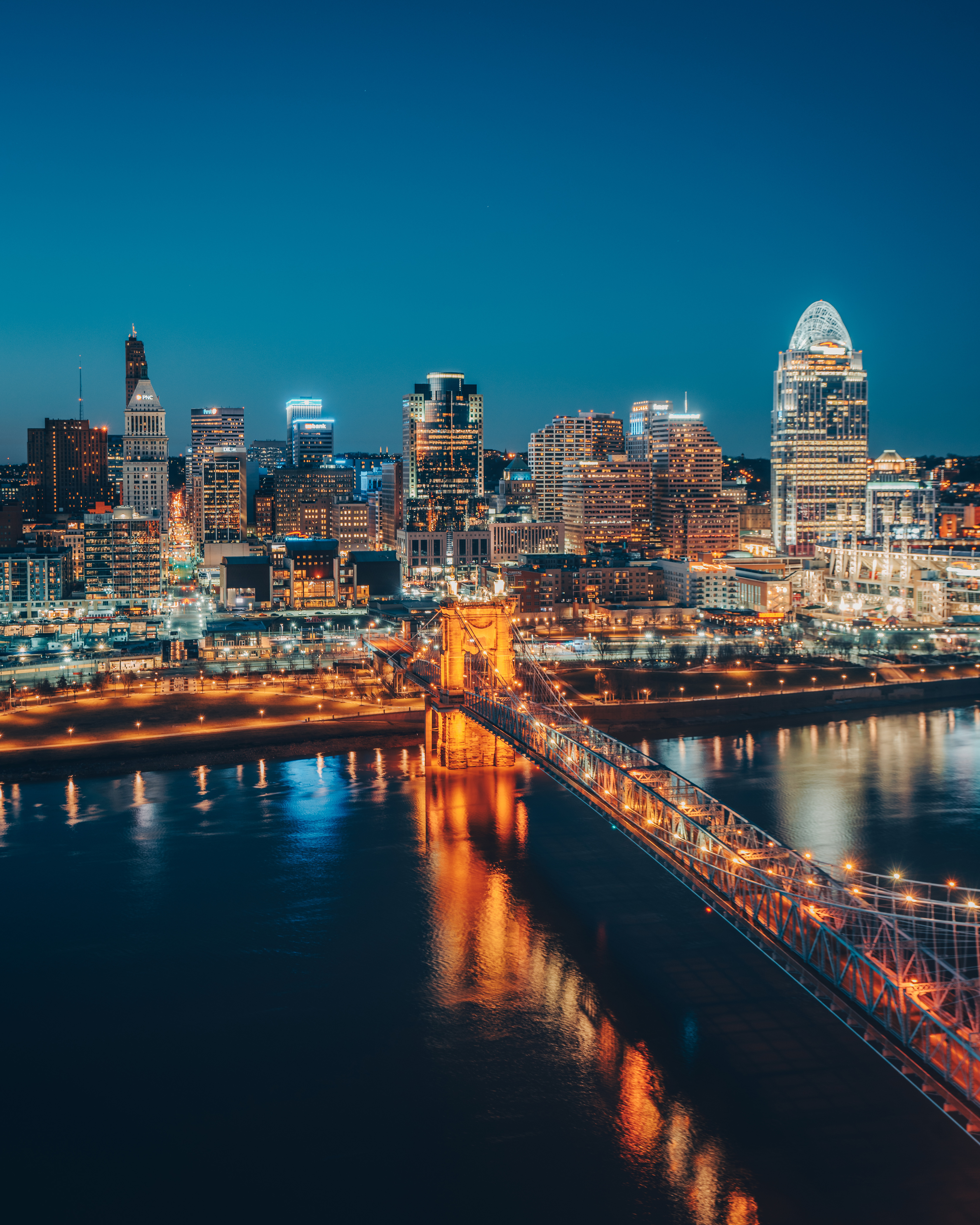 HDOhioCincy RegionCincinnati Skyline Nighttime Roebling Bridge Vertical 1