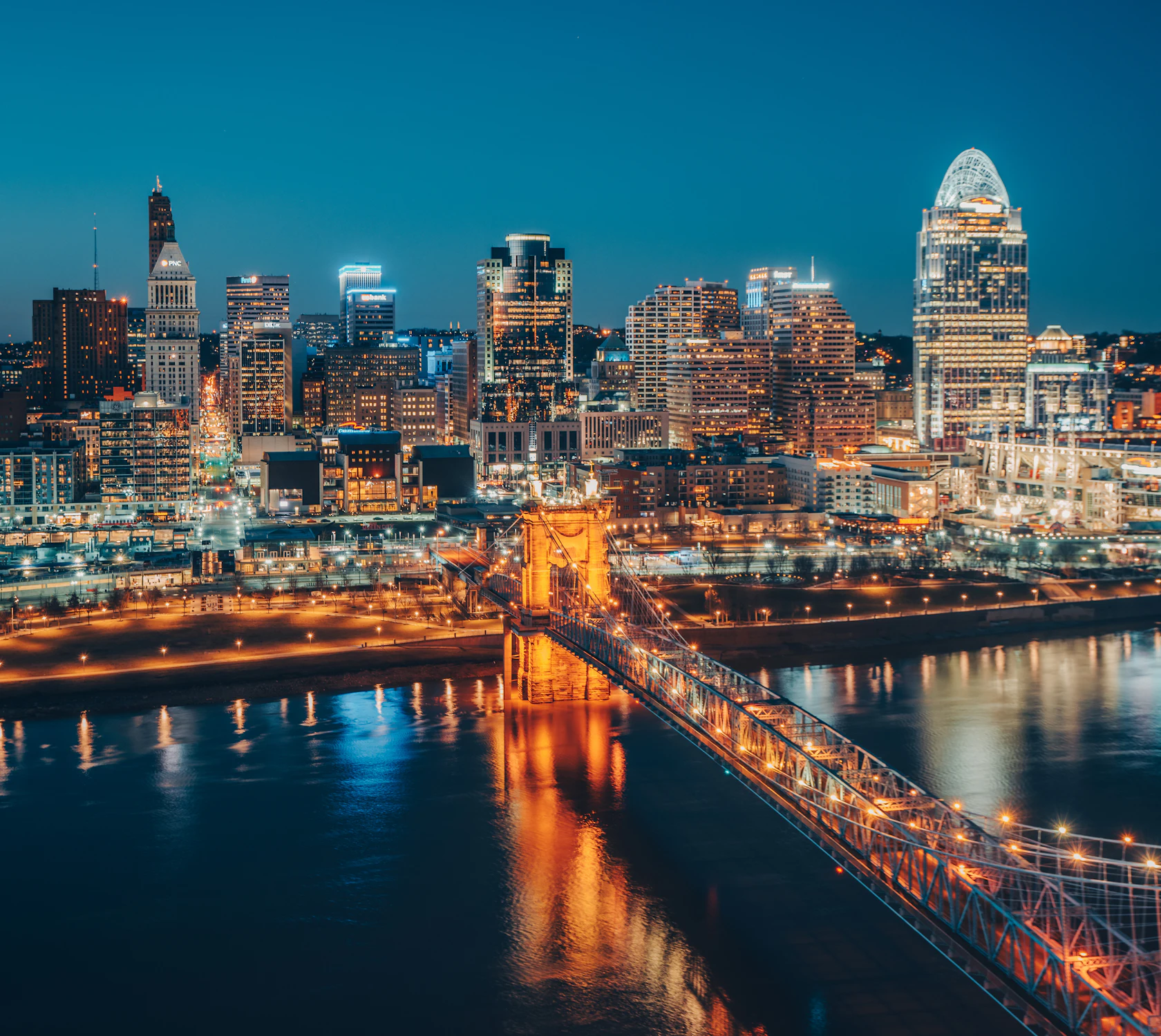 HDOhioCincy RegionCincinnati Skyline Nighttime Roebling Bridge Vertical 1
